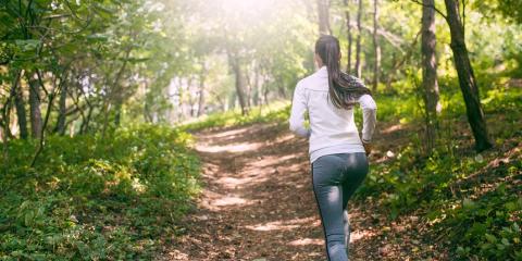 Lady running in the woods.